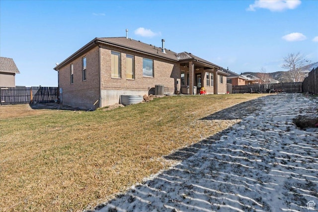 rear view of property featuring a lawn