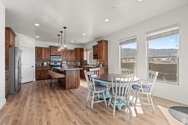 dining room featuring a mountain view and light hardwood / wood-style floors