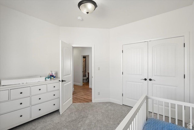 unfurnished bedroom featuring a closet and light carpet