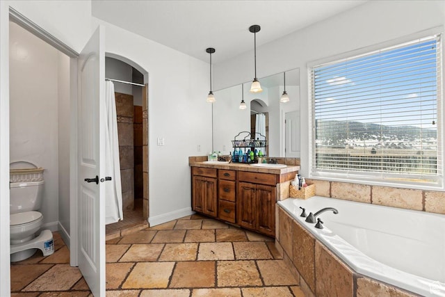 full bathroom with vanity, toilet, and separate shower and tub