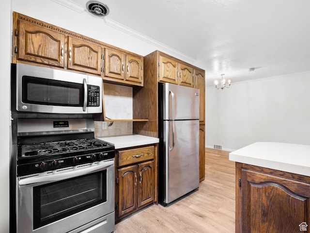 575 E 500 N, Pleasant Grove, UT 84062 - kitchen featuring stainless steel appliances, light wood-type flooring, an inviting chandelier, crown molding, and light countertops