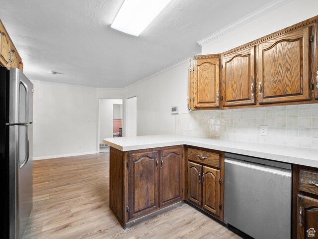 575 E 500 N, Pleasant Grove, UT 84062 - kitchen with stainless steel appliances, light countertops, light wood-style flooring, a peninsula, and tasteful backsplash