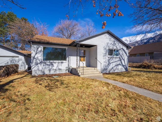 575 E 500 N, Pleasant Grove, UT 84062 - view of front of house featuring brick siding, a front lawn, and a mountain view
