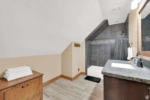 9284 E Tree Top Cir Unit 856, Heber City, UT 84032 - full bath featuring wood finished floors, vanity, shower / tub combination, vaulted ceiling, and baseboards