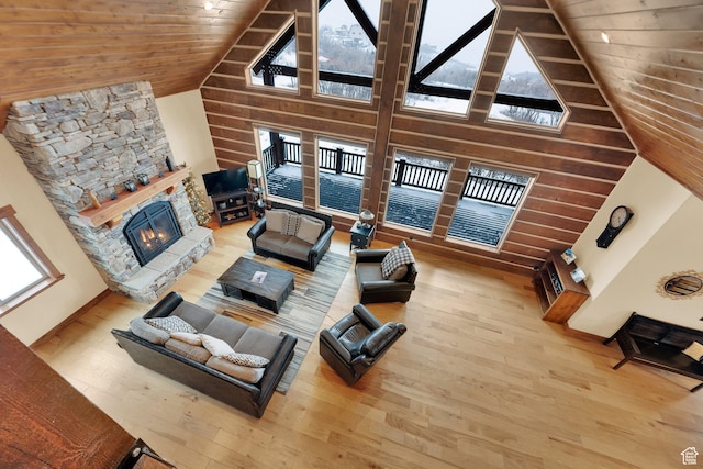 9284 E Tree Top Cir Unit 856, Heber City, UT 84032 - living room featuring wood finished floors, high vaulted ceiling, a stone fireplace, wooden ceiling, and wooden walls