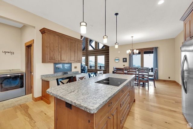 9284 E Tree Top Cir Unit 856, Heber City, UT 84032 - kitchen featuring washer / clothes dryer, freestanding refrigerator, a kitchen island, light wood-style floors, and recessed lighting