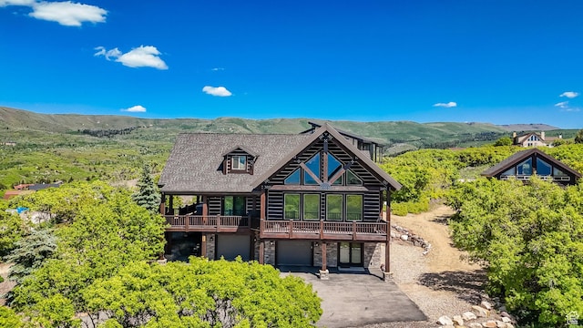 9284 E Tree Top Cir Unit 856, Heber City, UT 84032 - cabin featuring a garage, stone siding, driveway, and a mountain view