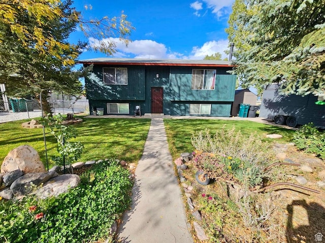 bi-level home with a front lawn