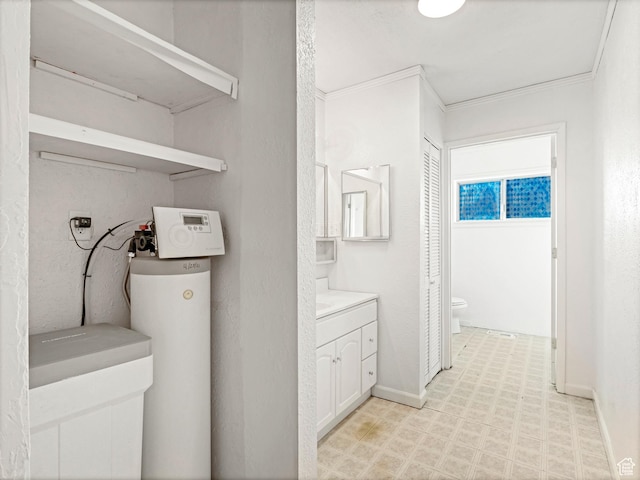 clothes washing area featuring crown molding and washer hookup