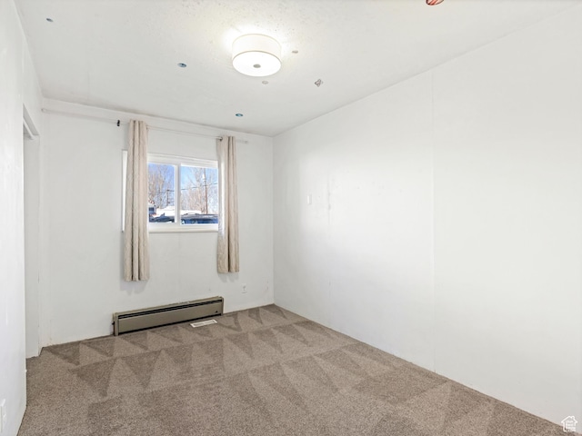 empty room with a baseboard radiator and light carpet