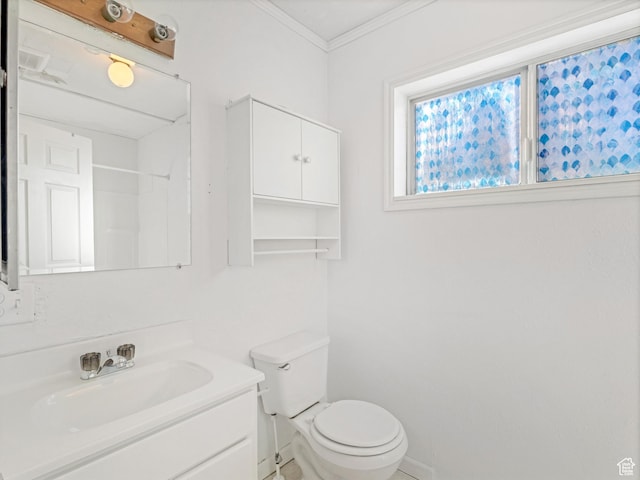 bathroom with crown molding, vanity, and toilet