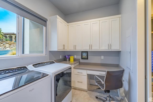 laundry room with cabinets, washer and dryer, and light tile patterned floors