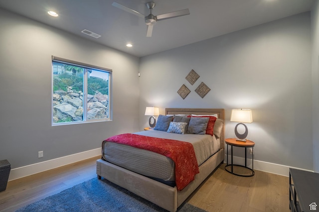 bedroom with ceiling fan and hardwood / wood-style floors