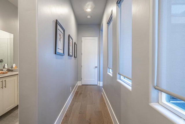 hallway with light hardwood / wood-style floors