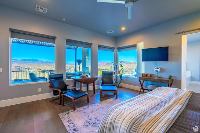 bedroom featuring a mountain view and dark wood-type flooring
