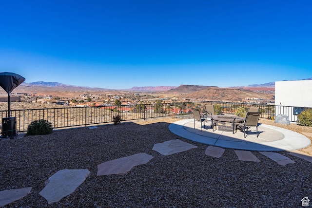 view of yard with a mountain view, a patio area, and an outdoor fire pit