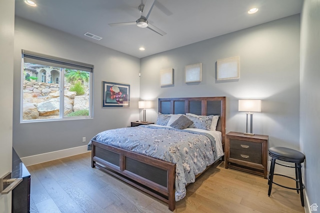 bedroom with ceiling fan and light hardwood / wood-style floors
