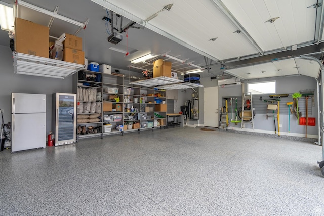 garage with white refrigerator and a garage door opener