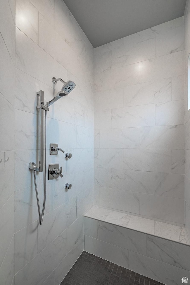bathroom with tiled shower