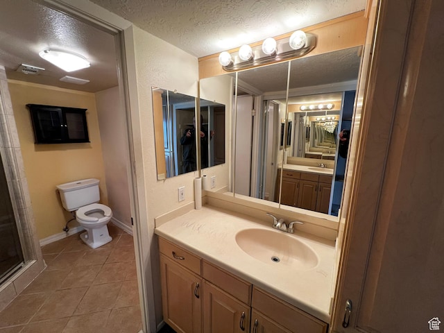 1080 E Quail Park Dr Unit J, Millcreek, UT 84117 - bathroom featuring baseboards, toilet, a textured ceiling, vanity, and tile patterned floors