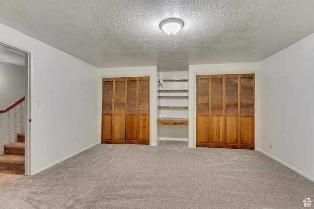 1503 N 1980 W, Provo, UT 84604 - unfurnished bedroom featuring two closets, a textured ceiling, carpet floors, and baseboards