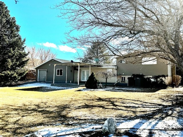 500 W Clark St S, Grantsville, UT 84029 - rear view of house featuring a garage, a lawn, and brick siding