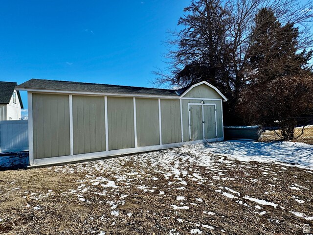 500 W Clark St S, Grantsville, UT 84029 - snow covered garage featuring fence and a storage unit