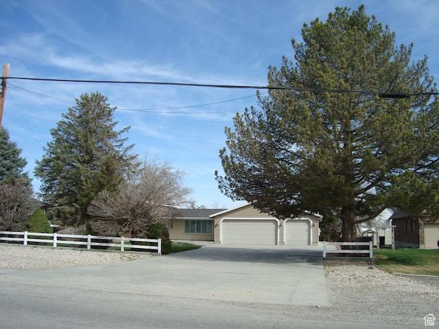 500 W Clark St S, Grantsville, UT 84029 - view of front of home featuring fence, a detached garage, and concrete driveway