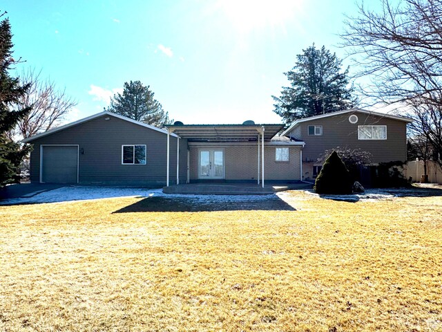 500 W Clark St S, Grantsville, UT 84029 - back of house with a yard, an attached garage, and french doors