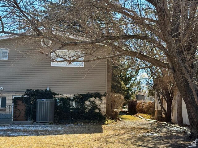 500 W Clark St S, Grantsville, UT 84029 - view of side of home with brick siding and central AC unit
