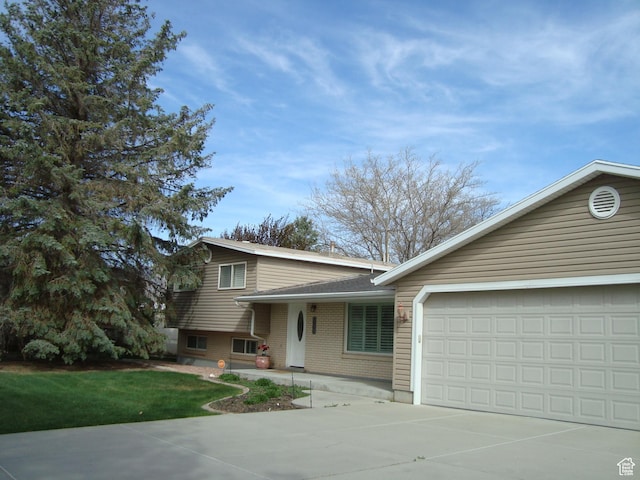 500 W Clark St S, Grantsville, UT 84029 - split level home featuring brick siding, driveway, and a garage