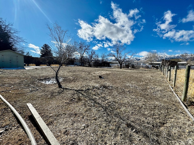 500 W Clark St S, Grantsville, UT 84029 - view of yard featuring an outdoor structure, fence, and a storage shed
