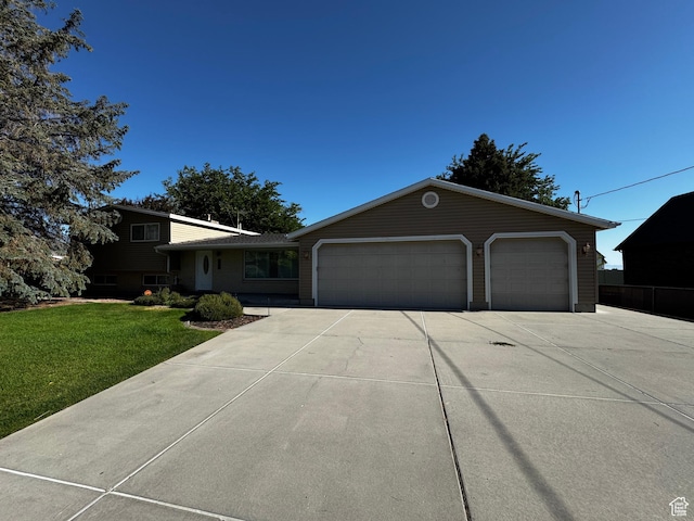 500 W Clark St S, Grantsville, UT 84029 - view of front of home with driveway, a front lawn, and a garage