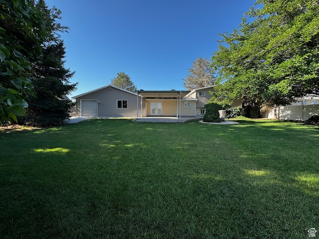 500 W Clark St S, Grantsville, UT 84029 - back of house featuring a yard and a garage