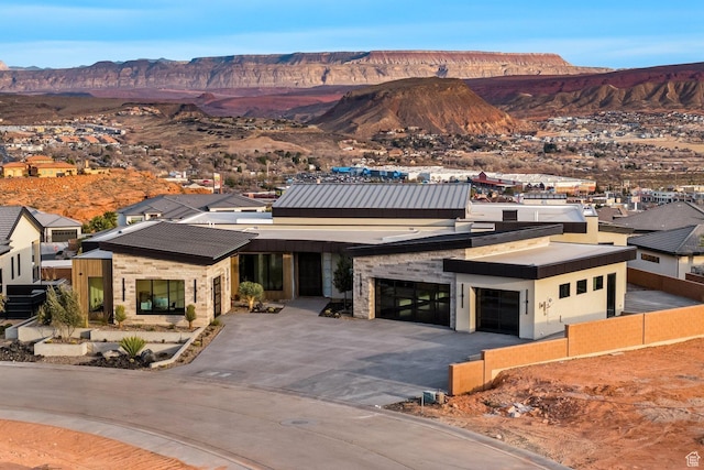 20 N Cliffside Dr, Washington, UT 84780 - view of front of property with driveway, an attached garage, fence, and a mountain view