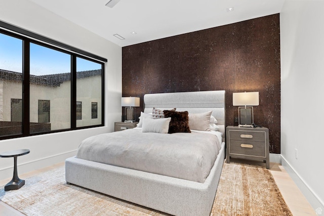20 N Cliffside Dr, Washington, UT 84780 - bedroom featuring an accent wall, wood finished floors, and baseboards