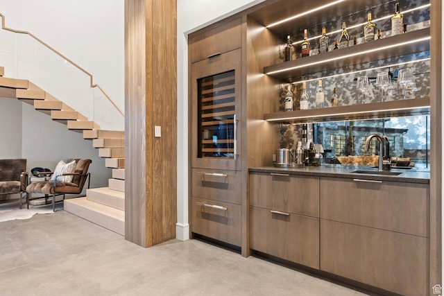 20 N Cliffside Dr, Washington, UT 84780 - bar featuring finished concrete flooring, stairs, wet bar, and a sink