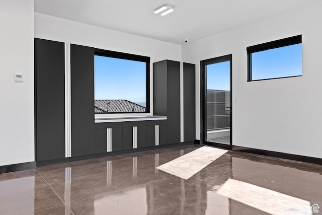 20 N Cliffside Dr, Washington, UT 84780 - empty room featuring marble finish floor, baseboards, and a wealth of natural light