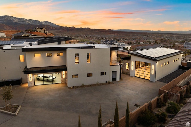 20 N Cliffside Dr, Washington, UT 84780 - view of front of property with concrete driveway, metal roof, a standing seam roof, roof mounted solar panels, and a mountain view