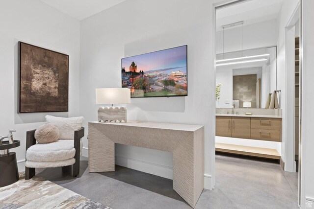 20 N Cliffside Dr, Washington, UT 84780 - bedroom featuring a sink, finished concrete floors, and connected bathroom