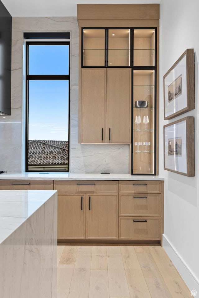 20 N Cliffside Dr, Washington, UT 84780 - kitchen featuring tasteful backsplash, light wood-style flooring, baseboards, and light brown cabinetry