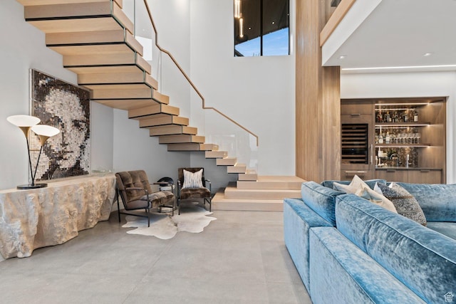 20 N Cliffside Dr, Washington, UT 84780 - living area with concrete flooring, stairway, a towering ceiling, and built in features