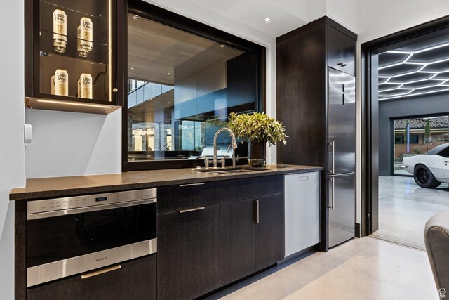 20 N Cliffside Dr, Washington, UT 84780 - bar featuring wall oven, stainless steel dishwasher, concrete floors, and a sink