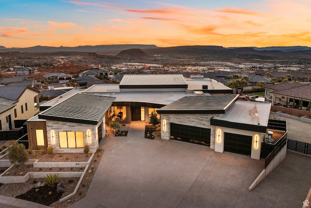 20 N Cliffside Dr, Washington, UT 84780 - contemporary house featuring a garage, stone siding, driveway, and a mountain view