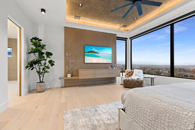 20 N Cliffside Dr, Washington, UT 84780 - bedroom with ceiling fan, a raised ceiling, hardwood / wood-style flooring, and baseboards