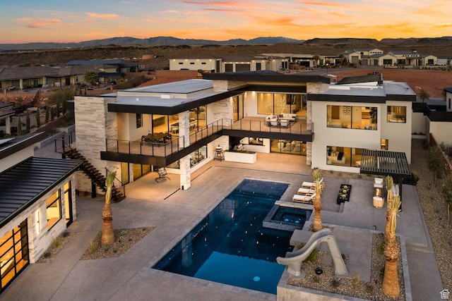 20 N Cliffside Dr, Washington, UT 84780 - rear view of property with a patio, a balcony, a residential view, a pool with connected hot tub, and a mountain view