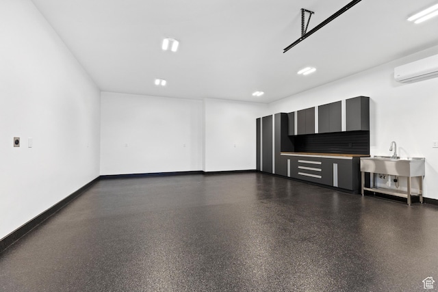 20 N Cliffside Dr, Washington, UT 84780 - garage featuring baseboards and a wall mounted air conditioner