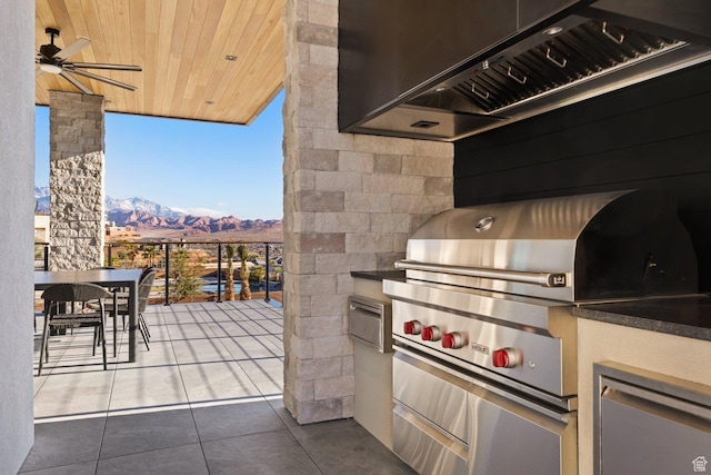 20 N Cliffside Dr, Washington, UT 84780 - view of patio with exterior kitchen, outdoor dining area, a grill, and a mountain view