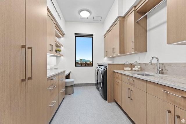 20 N Cliffside Dr, Washington, UT 84780 - laundry room with washer and clothes dryer, light floors, cabinet space, a sink, and baseboards