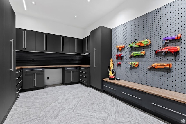 20 N Cliffside Dr, Washington, UT 84780 - interior space with butcher block counters, built in study area, and dark cabinetry
